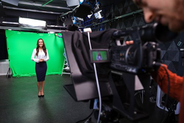 video production in front of a green screen in a studio